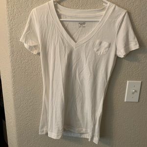 A white Olin tee with a small detail pocket